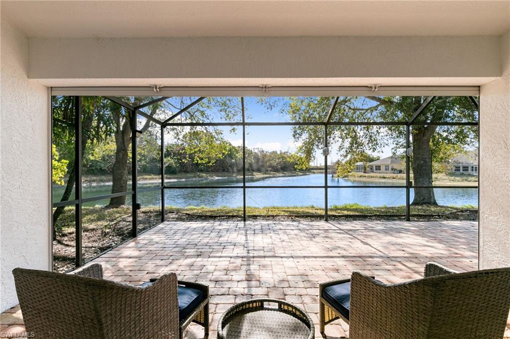 7867 Gardner Drive Naples, FL 34109 - Photo 24 of 36 View of patio / terrace with a sunroom, glass enclosure, and a water view
