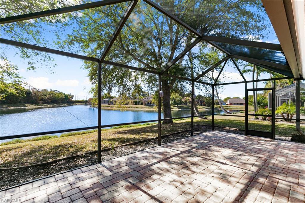 7867 Gardner Drive Naples, FL 34109 - Photo 25 of 36 Unfurnished sunroom with a water view and a patio area