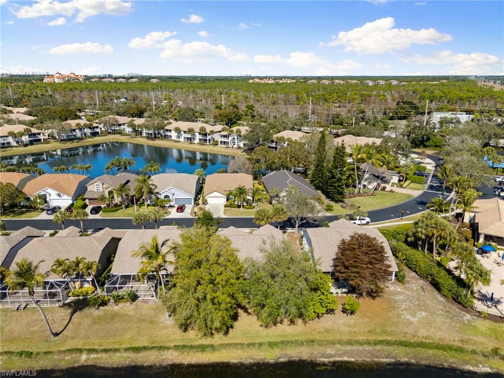 7867 Gardner Drive Naples, FL 34109 - Photo 30 of 36 Aerial perspective of suburban area featuring a large body of water and a tree filled landscape