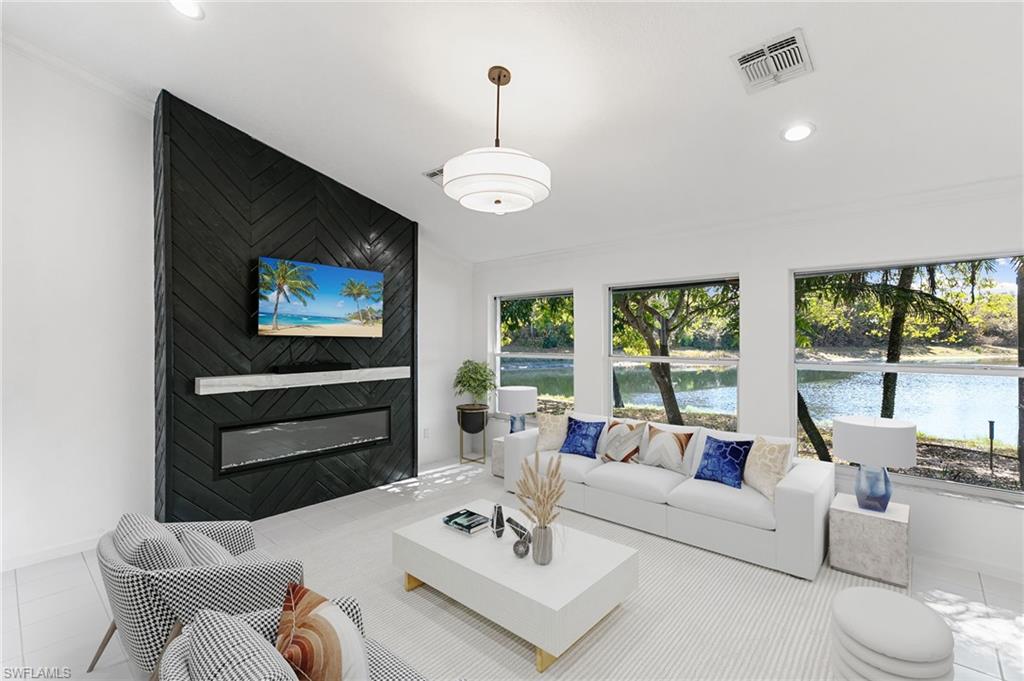 7867 Gardner Drive Naples, FL 34109 - Photo 5 of 36 Virtually Staged-Living room featuring a large fireplace, crown molding, recessed lighting, and tile patterned floors
