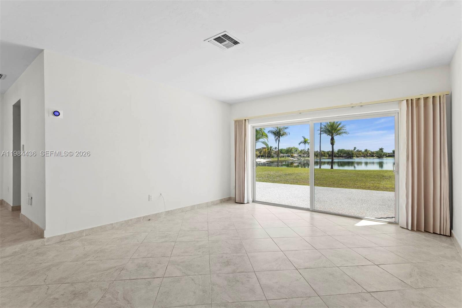 11807 Southwest 112th Avenue Miami, FL 33176 - Photo 19 of 48 an empty room with floor to ceiling window and an outdoor view