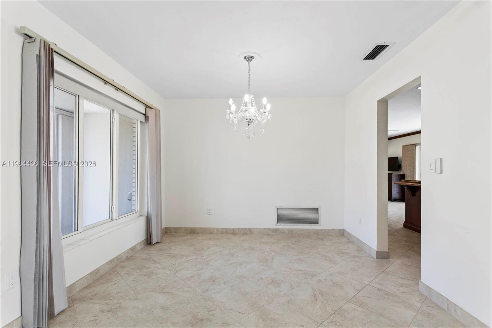 11807 Southwest 112th Avenue Miami, FL 33176 - Photo 21 of 48 a view of a chandelier in big room and a bathroom