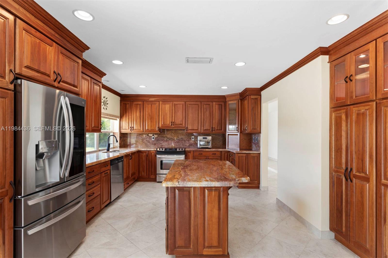 11807 Southwest 112th Avenue Miami, FL 33176 - Photo 24 of 48 a kitchen with stainless steel appliances granite countertop a refrigerator a sink a stove and island