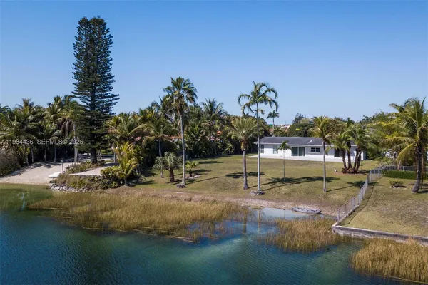 an aerial view of residential house with outdoor space and lake view