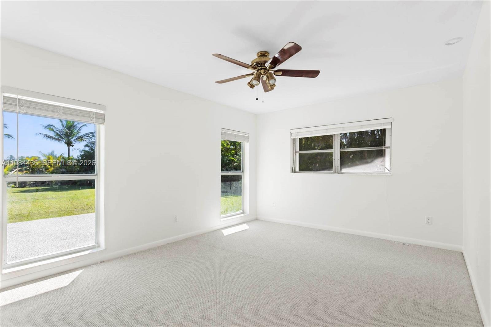 11807 Southwest 112th Avenue Miami, FL 33176 - Photo 7 of 48 a view of a livingroom with a ceiling fan and window