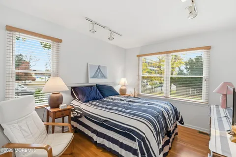 a bedroom with a bed and windows