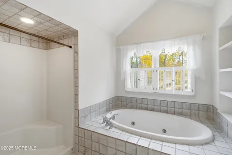 a white bath tub sitting next to a window