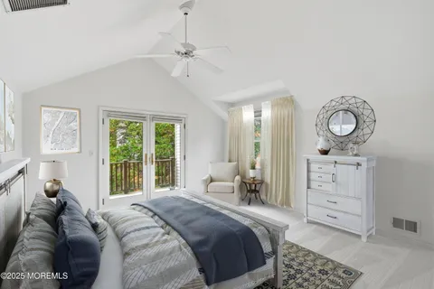 a bed room with a bed a mirror and a window