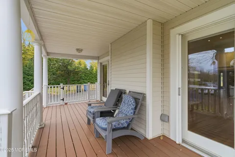 a balcony with furniture and wooden floor