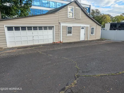 a view of a house with a backyard and a garage