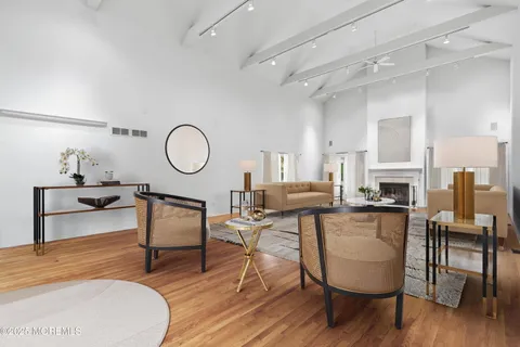 a living room with furniture a fireplace and kitchen view