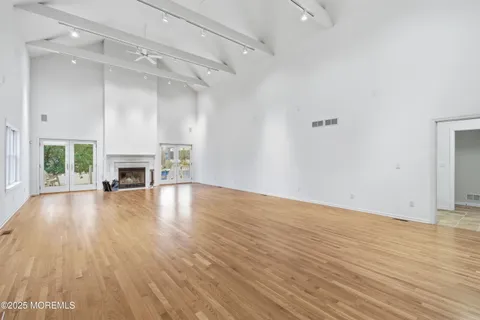 wooden floor in an empty room with a fireplace