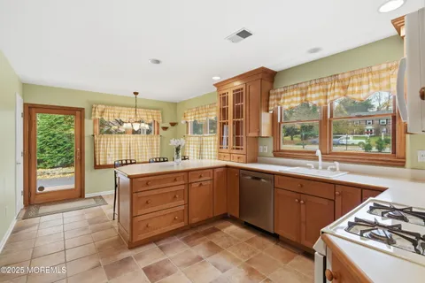 a large kitchen with a window and cabinets