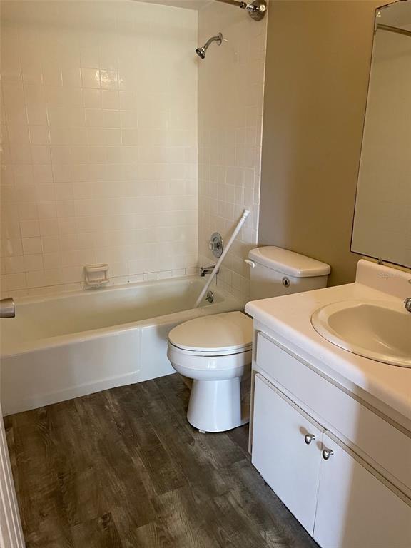 4800 Rilma Avenue, Unit 146 Sarasota, FL 34234 - Photo 12 of 15 a bathroom with a granite countertop toilet a sink and a bathtub