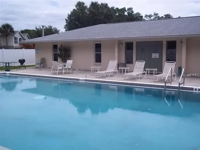 a view of a patio with swimming pool table and chairs