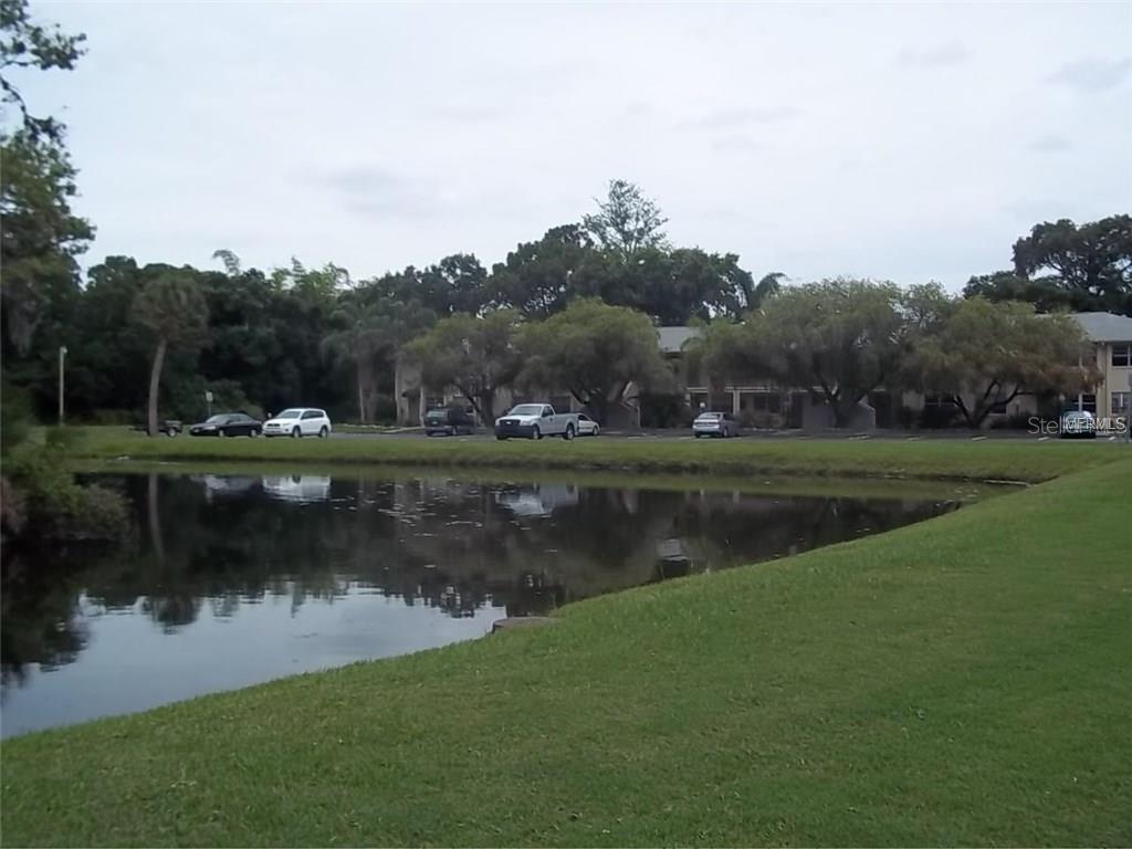4800 Rilma Avenue, Unit 146 Sarasota, FL 34234 - Photo 15 of 15 a view of a lake with houses in the back