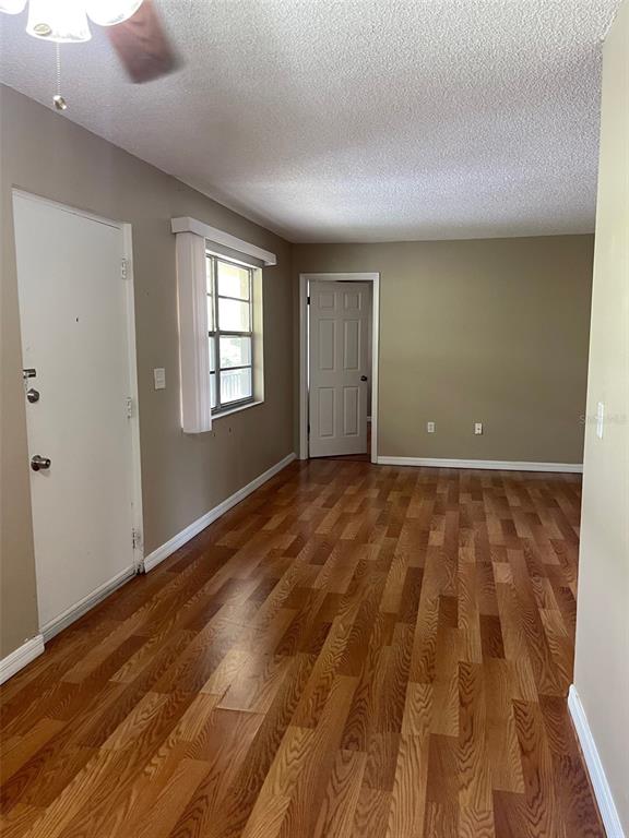 4800 Rilma Avenue, Unit 146 Sarasota, FL 34234 - Photo 2 of 15 a view of room with window and hardwood floor