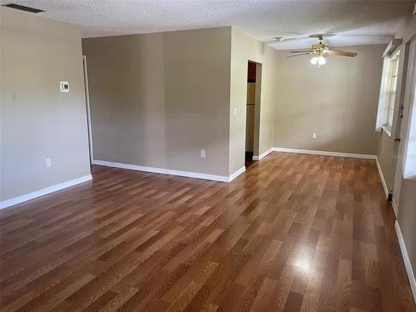 wooden floor in an empty room with a window