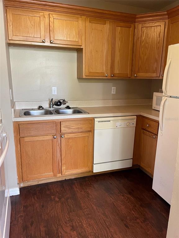 4800 Rilma Avenue, Unit 146 Sarasota, FL 34234 - Photo 6 of 15 a kitchen with granite countertop cabinets stainless steel appliances a sink and wooden floor