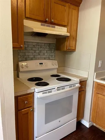 a stove top oven sitting inside of a kitchen