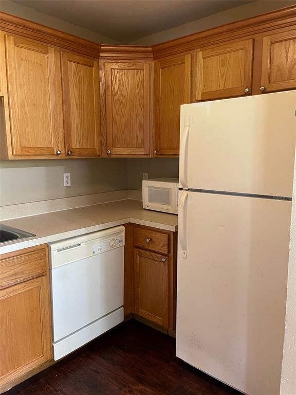 4800 Rilma Avenue, Unit 146 Sarasota, FL 34234 - Photo 8 of 15 a white refrigerator freezer sitting in a kitchen