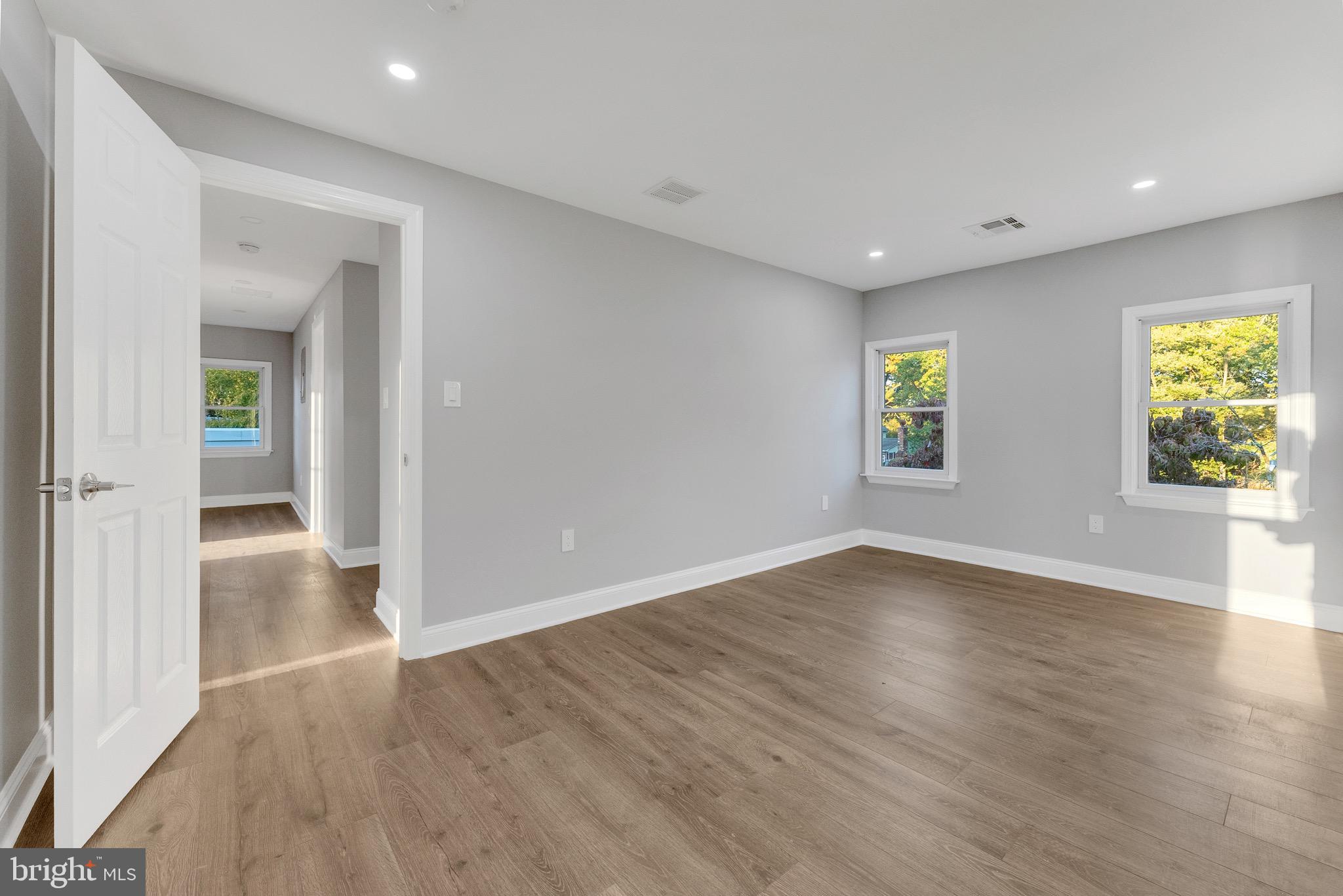 15 North Main Street, Unit B Pennington, NJ 08534 - Photo 11 of 15 an empty room with wooden floor and windows