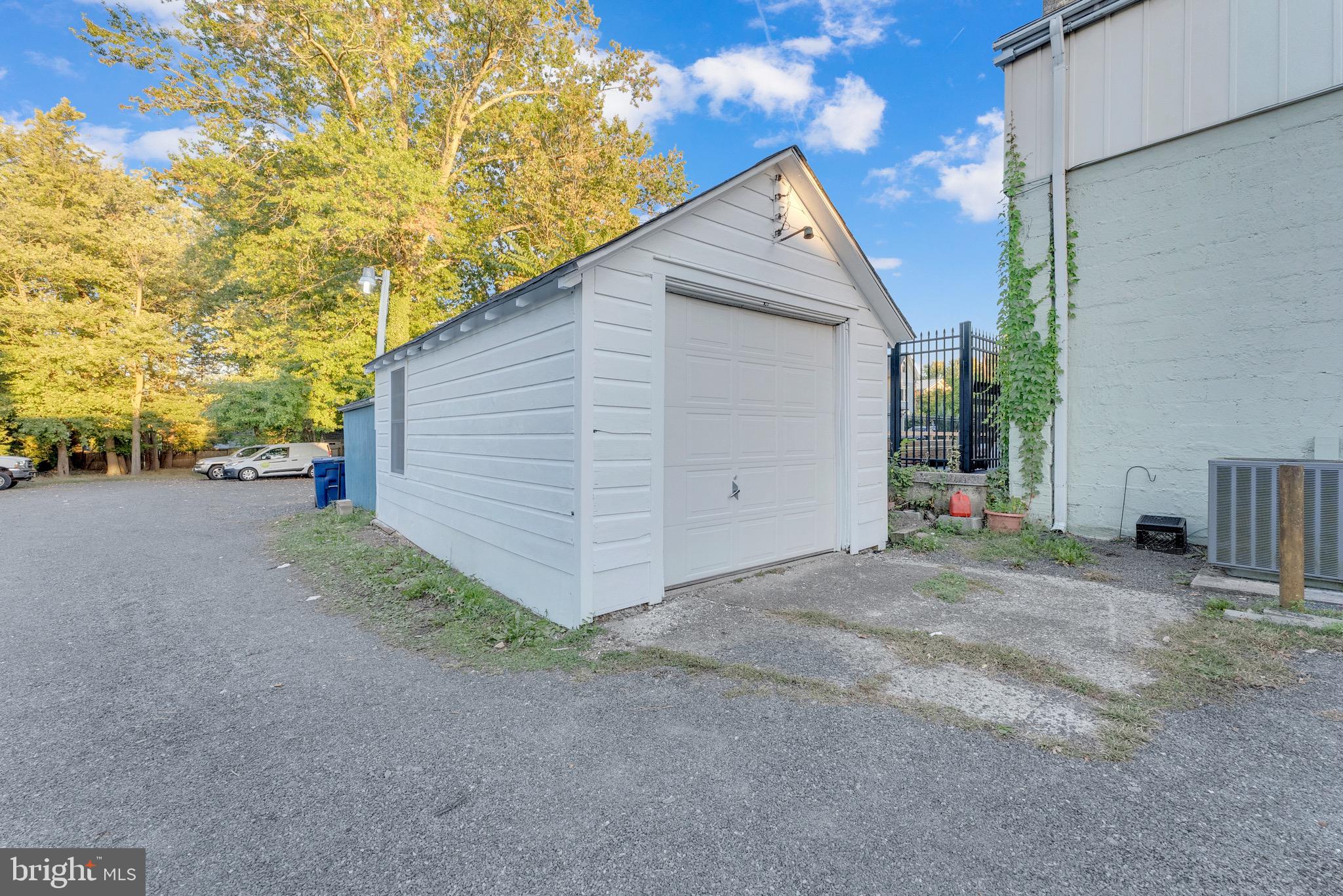 15 North Main Street, Unit B Pennington, NJ 08534 - Photo 13 of 15 a view of a house with a yard and garage