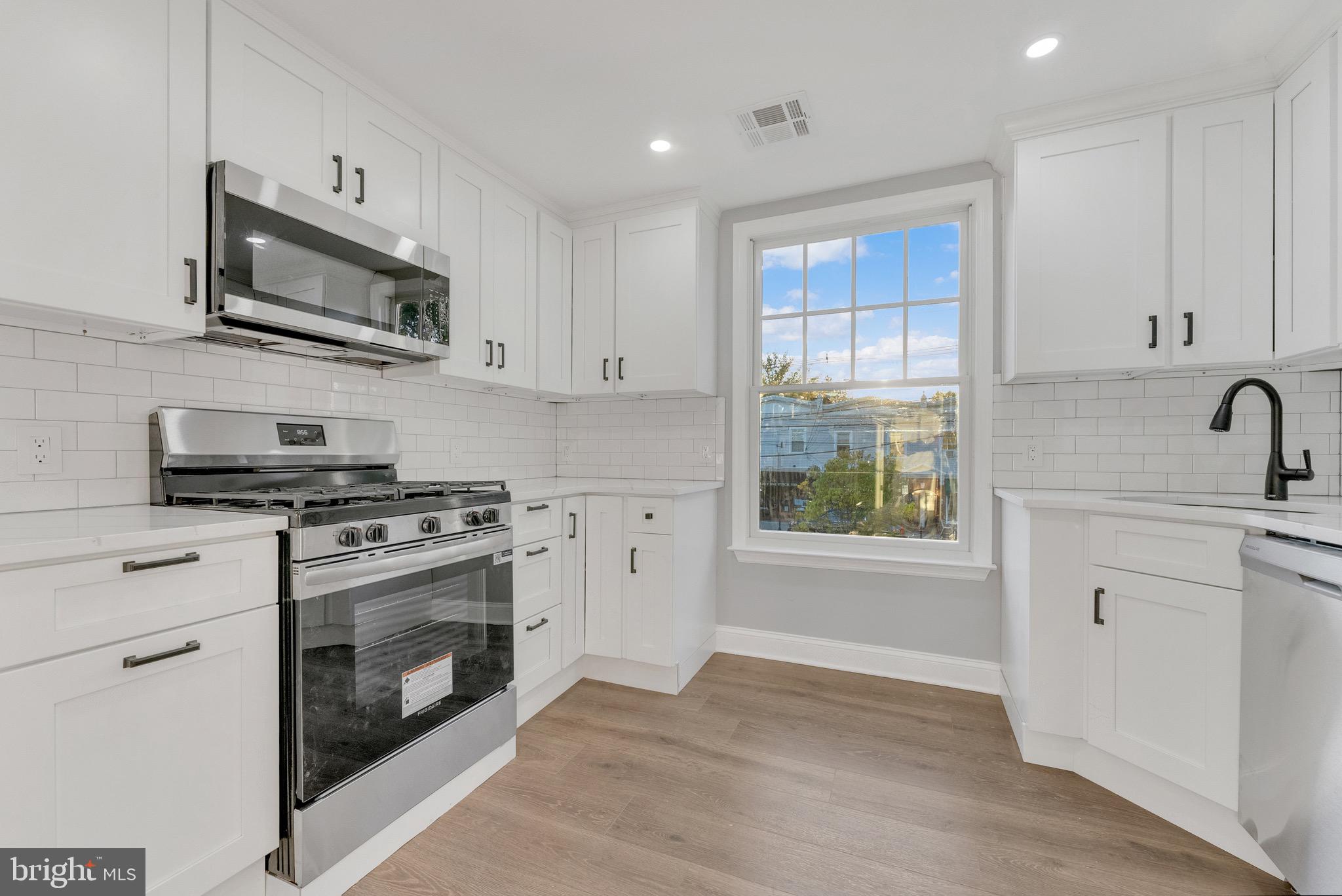 15 North Main Street, Unit B Pennington, NJ 08534 - Photo 3 of 15 a kitchen with stainless steel appliances granite countertop a stove a sink and a microwave