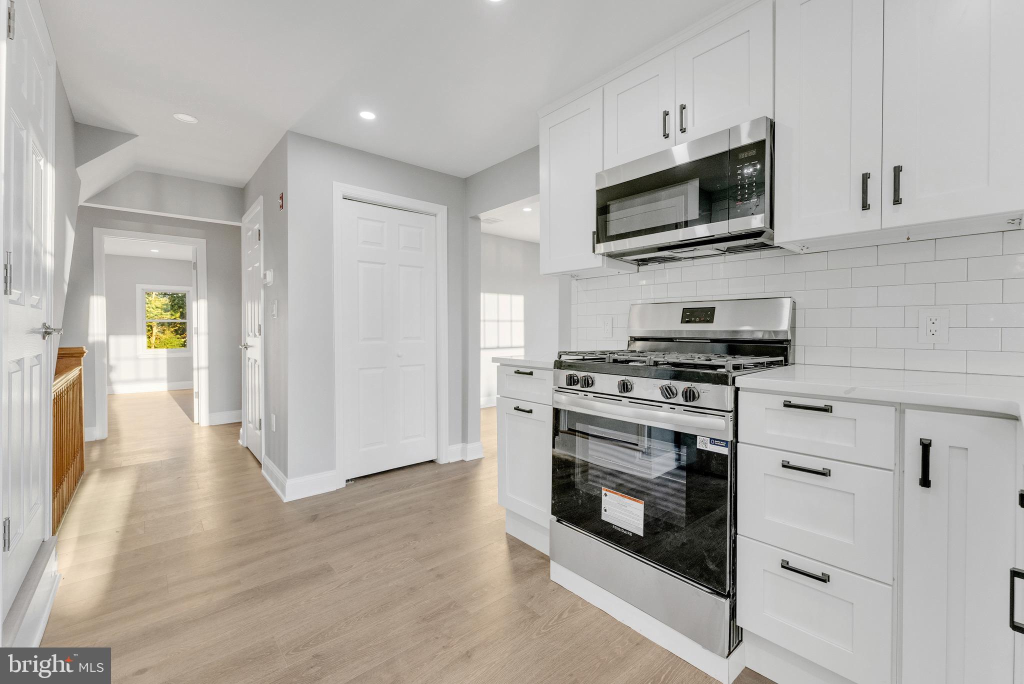 15 North Main Street, Unit B Pennington, NJ 08534 - Photo 4 of 15 a kitchen with stainless steel appliances a stove a microwave and sink