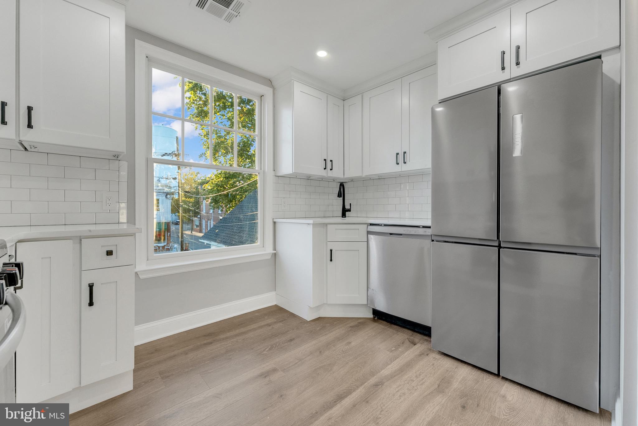 15 North Main Street, Unit B Pennington, NJ 08534 - Photo 5 of 15 a kitchen with white cabinets and white appliances