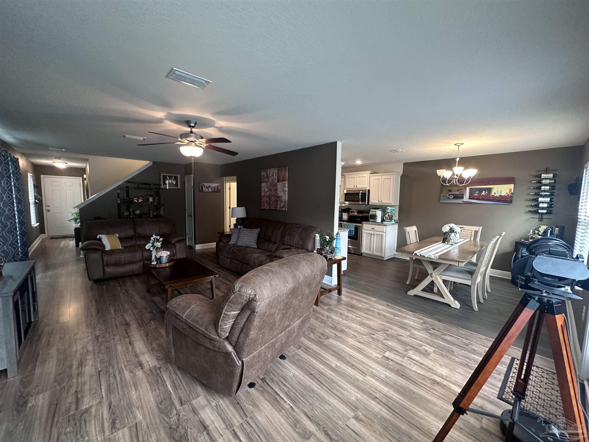 5217 Saufley Field Road Pensacola, FL 32526 - Photo 4 of 26 a living room with furniture and a wooden floor