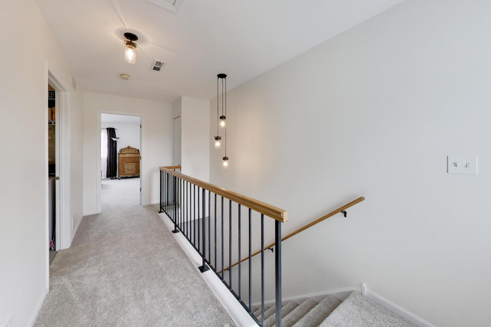 17804 Braewick Road Gurnee, IL 60031 - Photo 14 of 27 a view of a hallway with wooden floor and entryway