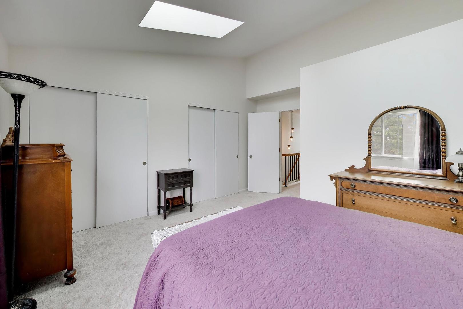 17804 Braewick Road Gurnee, IL 60031 - Photo 17 of 27 a bedroom with a bed and a fireplace