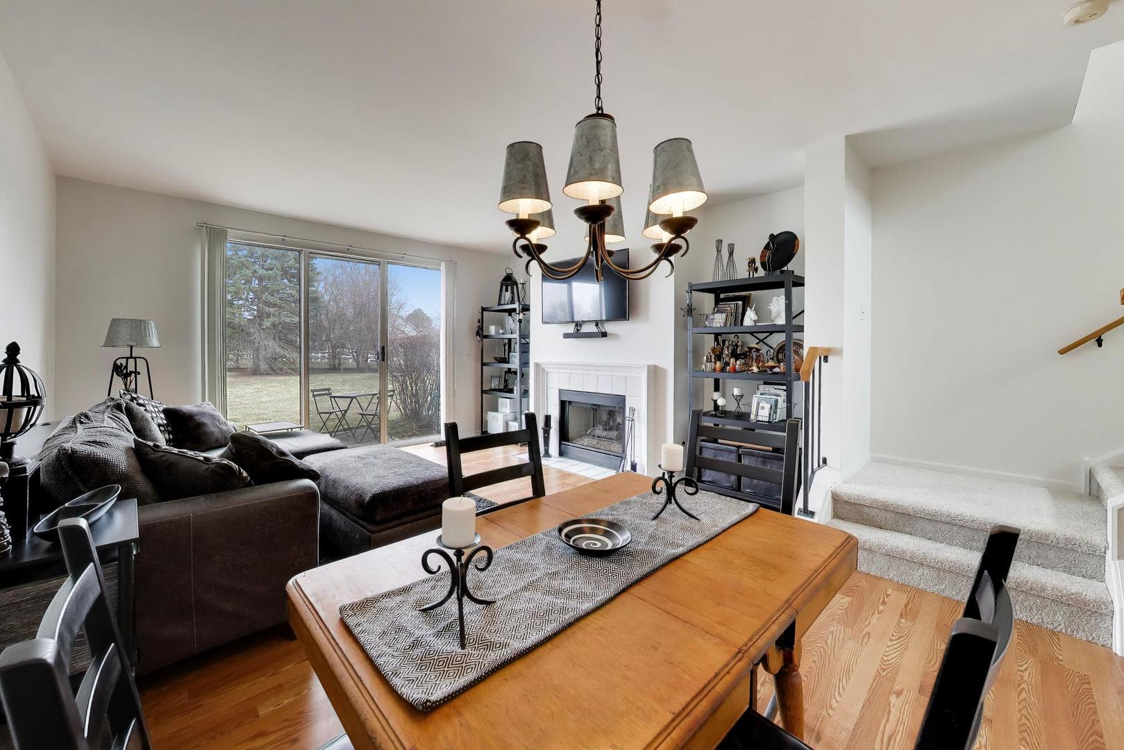 17804 Braewick Road Gurnee, IL 60031 - Photo 9 of 27 a living room with fireplace furniture and a chandelier