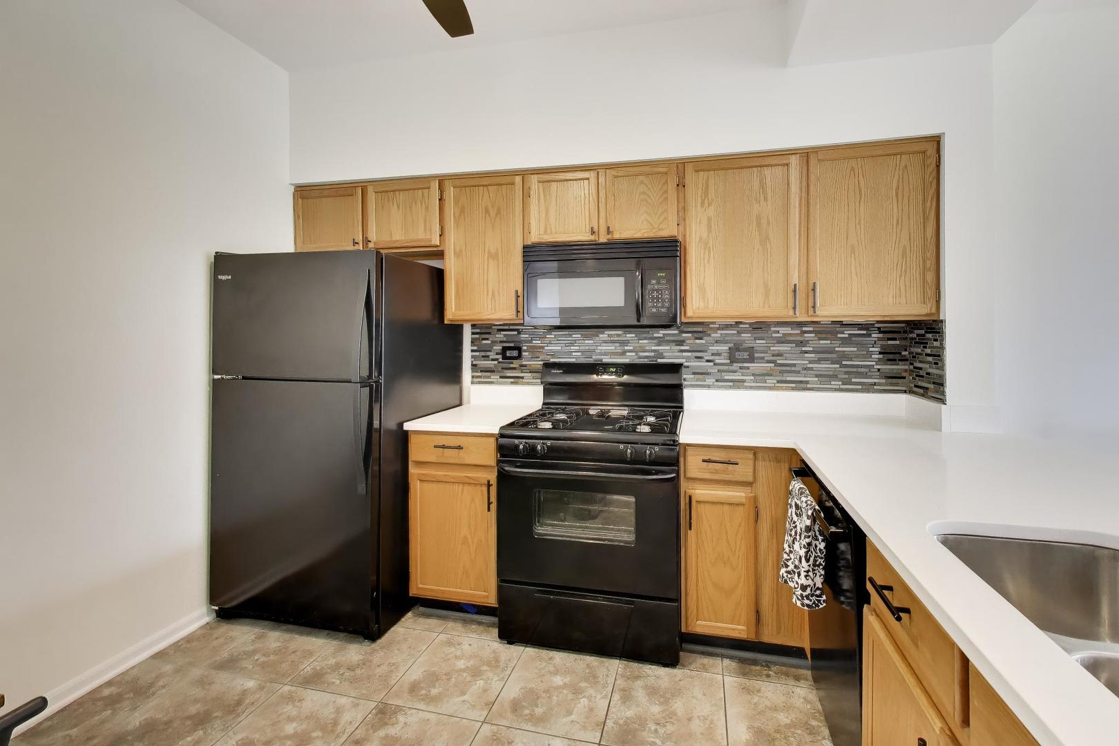 17804 Braewick Road Gurnee, IL 60031 - Photo 10 of 27 a kitchen with stainless steel appliances granite countertop a refrigerator stove and sink