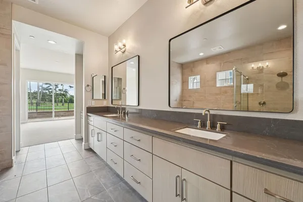 a bathroom with a granite countertop sink mirror and double