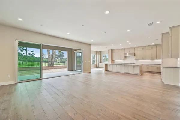 a view of a kitchen with a sink and a large window