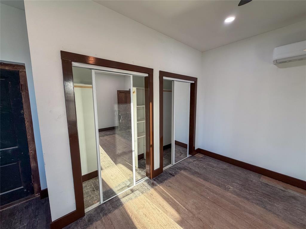 107 East Stone Street, Unit B Collinsville, TX 76233 - Photo 11 of 16 an empty room with wooden floor and entrance
