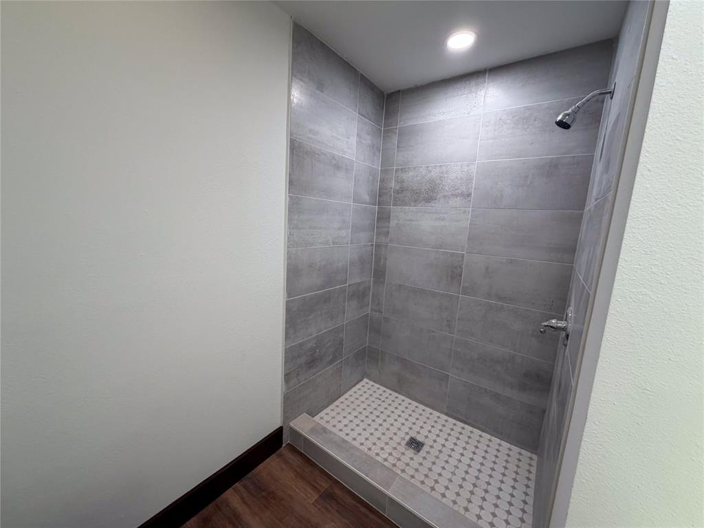 107 East Stone Street, Unit B Collinsville, TX 76233 - Photo 12 of 16 a bathroom with a shower