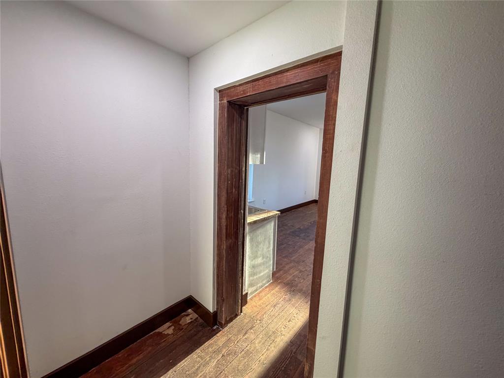 107 East Stone Street, Unit B Collinsville, TX 76233 - Photo 14 of 16 a view of a hallway with wooden floor