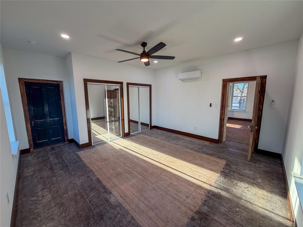 107 East Stone Street, Unit B Collinsville, TX 76233 - Photo 7 of 16 an empty room with wooden floor and ceiling fan