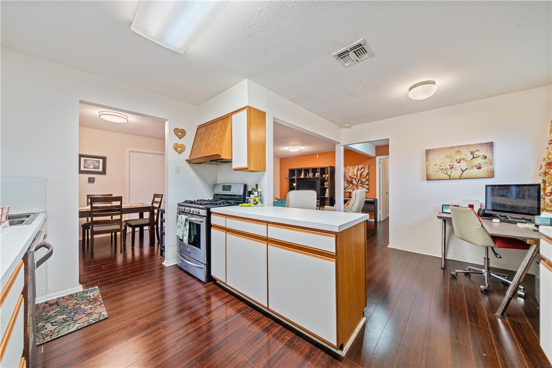 4338 Yucca Street Corpus Christi, TX 78411 - Photo 12 of 31 a open kitchen with stainless steel appliances granite countertop a stove and a wooden floors