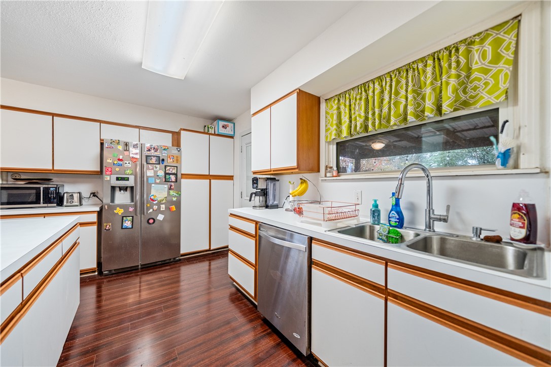 4338 Yucca Street Corpus Christi, TX 78411 - Photo 13 of 31 a kitchen with stainless steel appliances a sink dishwasher stove and refrigerator