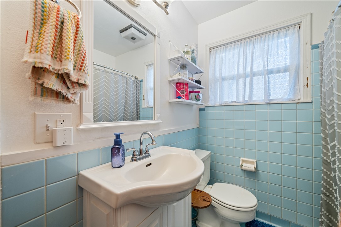 4338 Yucca Street Corpus Christi, TX 78411 - Photo 16 of 31 a bathroom with a sink a toilet and a mirror