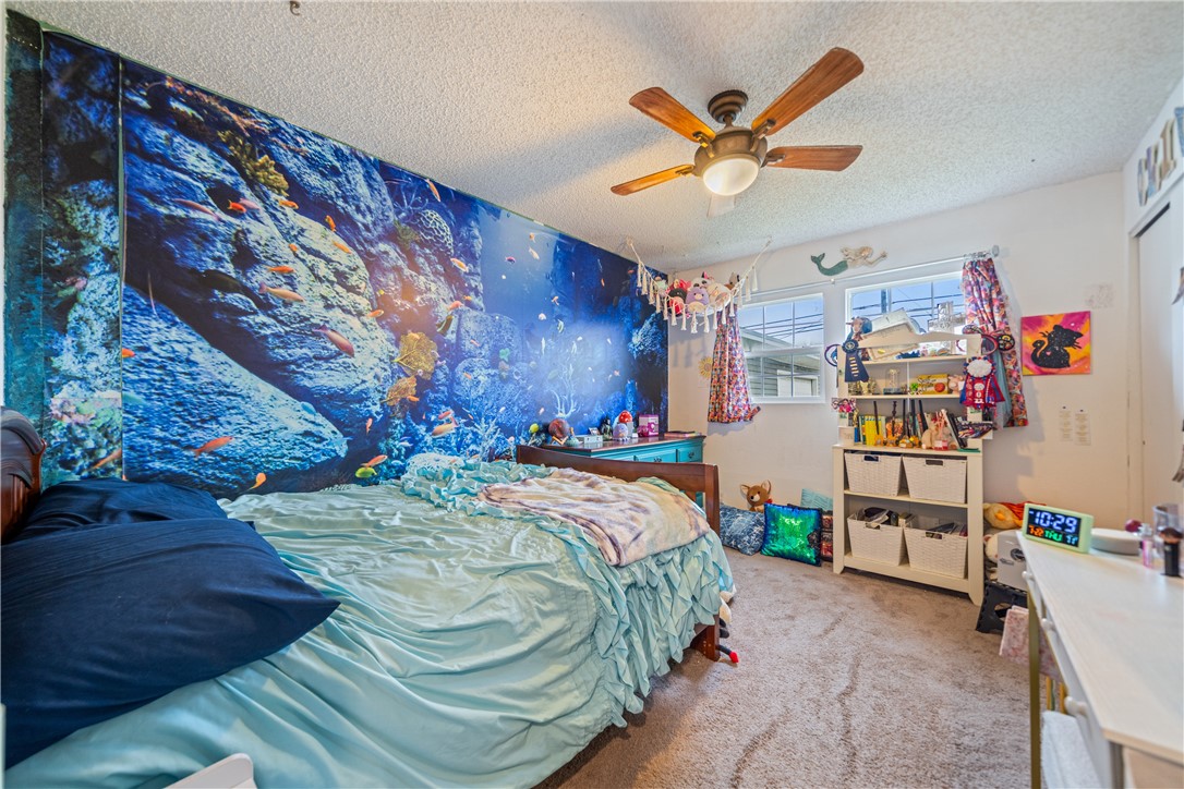 4338 Yucca Street Corpus Christi, TX 78411 - Photo 17 of 31 a bed room with a bed and a chandelier