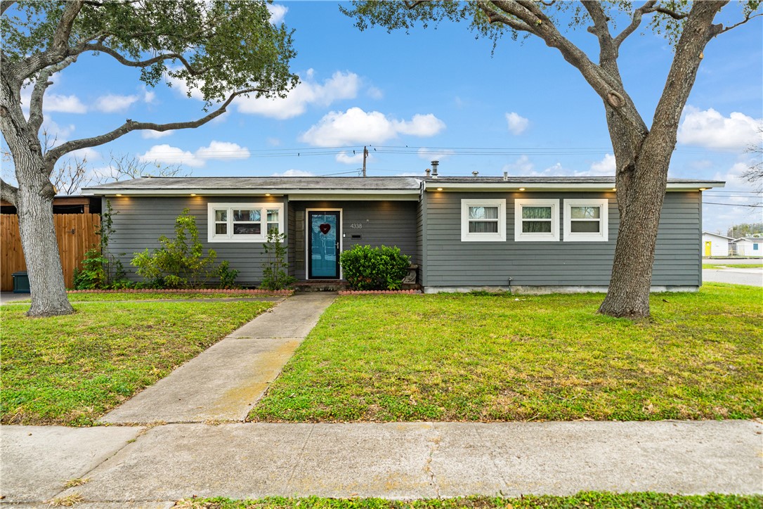 4338 Yucca Street Corpus Christi, TX 78411 - Photo 2 of 31 a front view of a house with garden