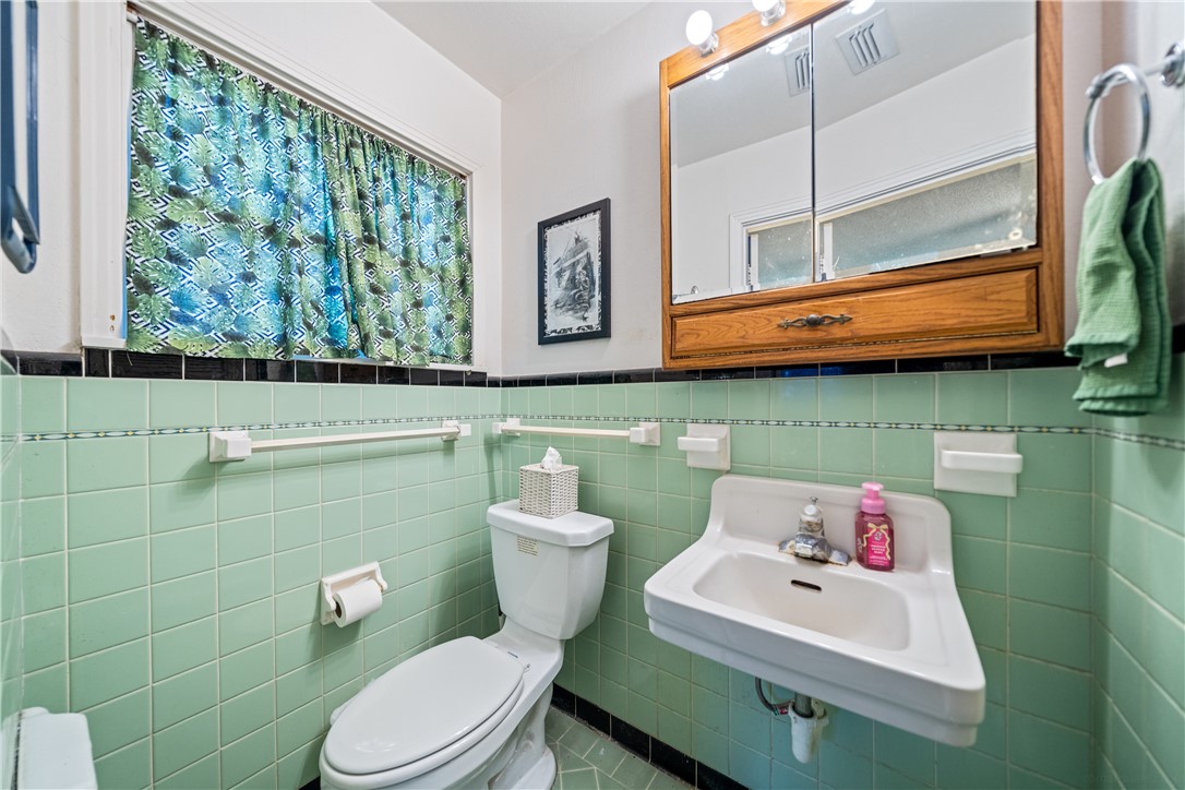 4338 Yucca Street Corpus Christi, TX 78411 - Photo 21 of 31 a bathroom with a toilet sink and mirror