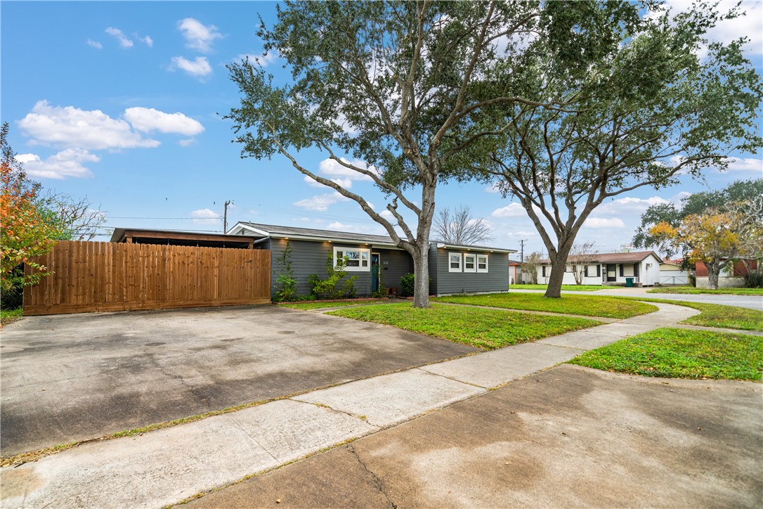 4338 Yucca Street Corpus Christi, TX 78411 - Photo 3 of 31 a front view of a house with a yard and garage
