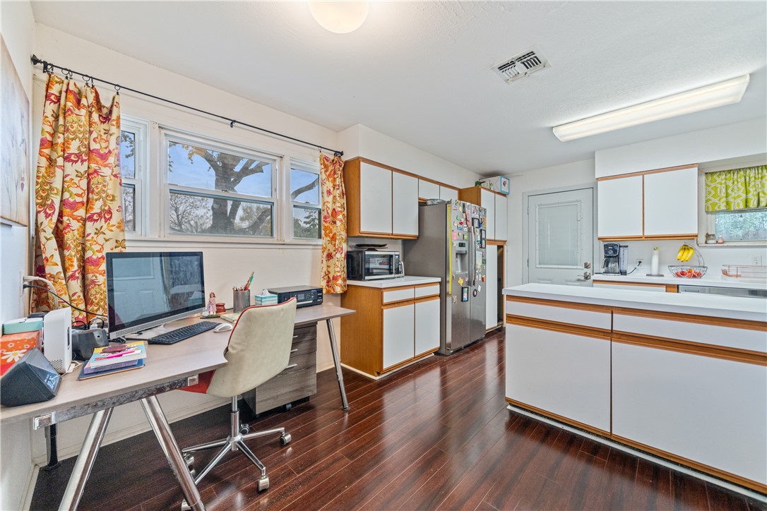 4338 Yucca Street Corpus Christi, TX 78411 - Photo 10 of 31 a kitchen with a refrigerator cabinets and wooden floor