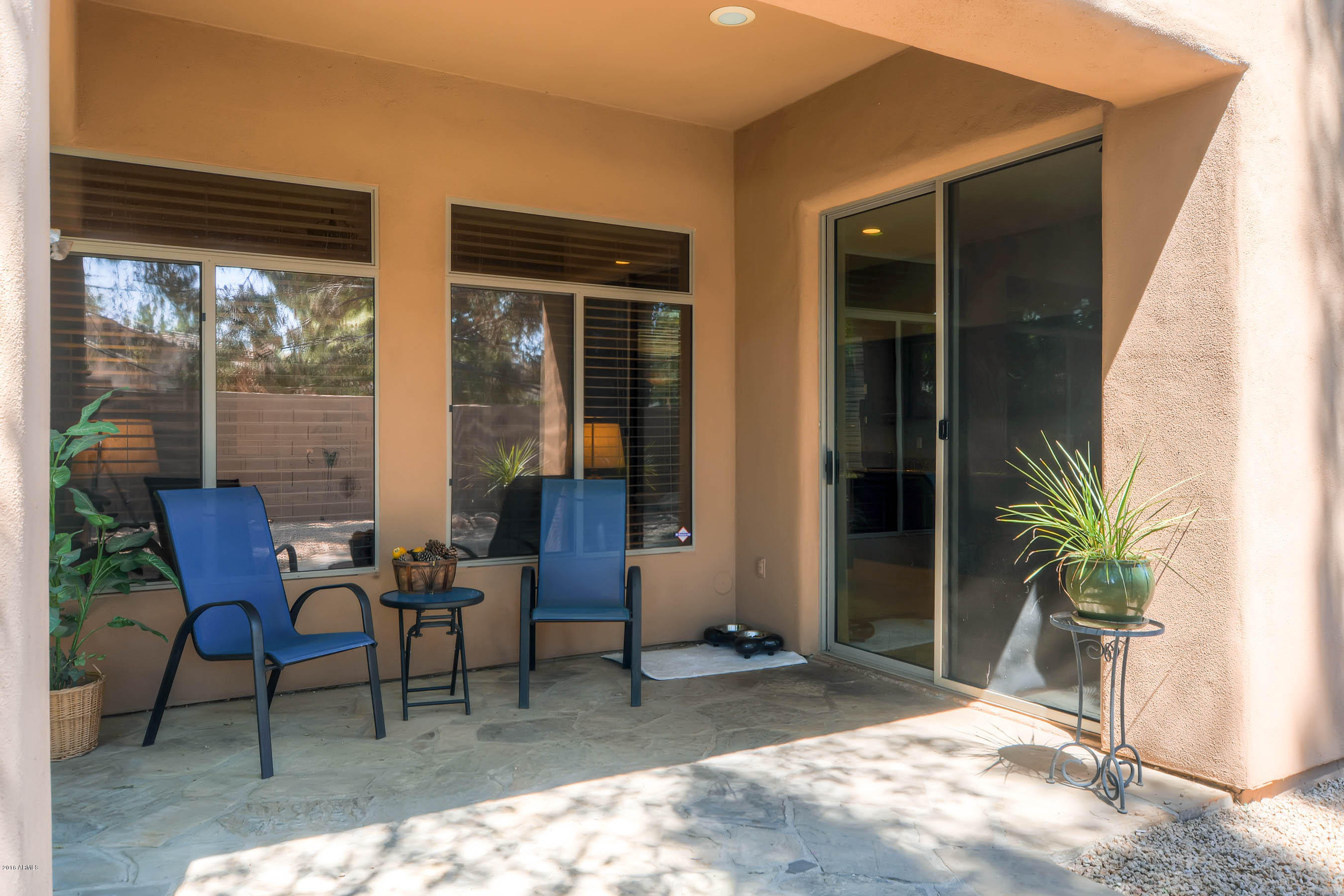 3829 East Carson Road Phoenix, AZ 85042 - Photo 25 of 28 a view of a house with backyard sitting area and porch